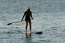 Woman paddle surfing